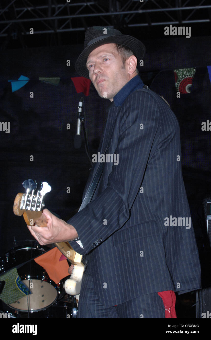 Paul Simonon performing live on stage with bass guitar