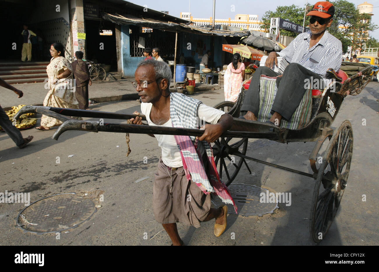 A rickshaw puller carrying a customer on the occasion of International
