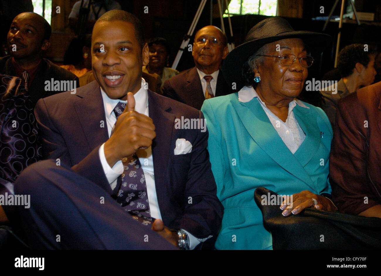 JayZ (L), giving a thumbs up, seated with family in City Council