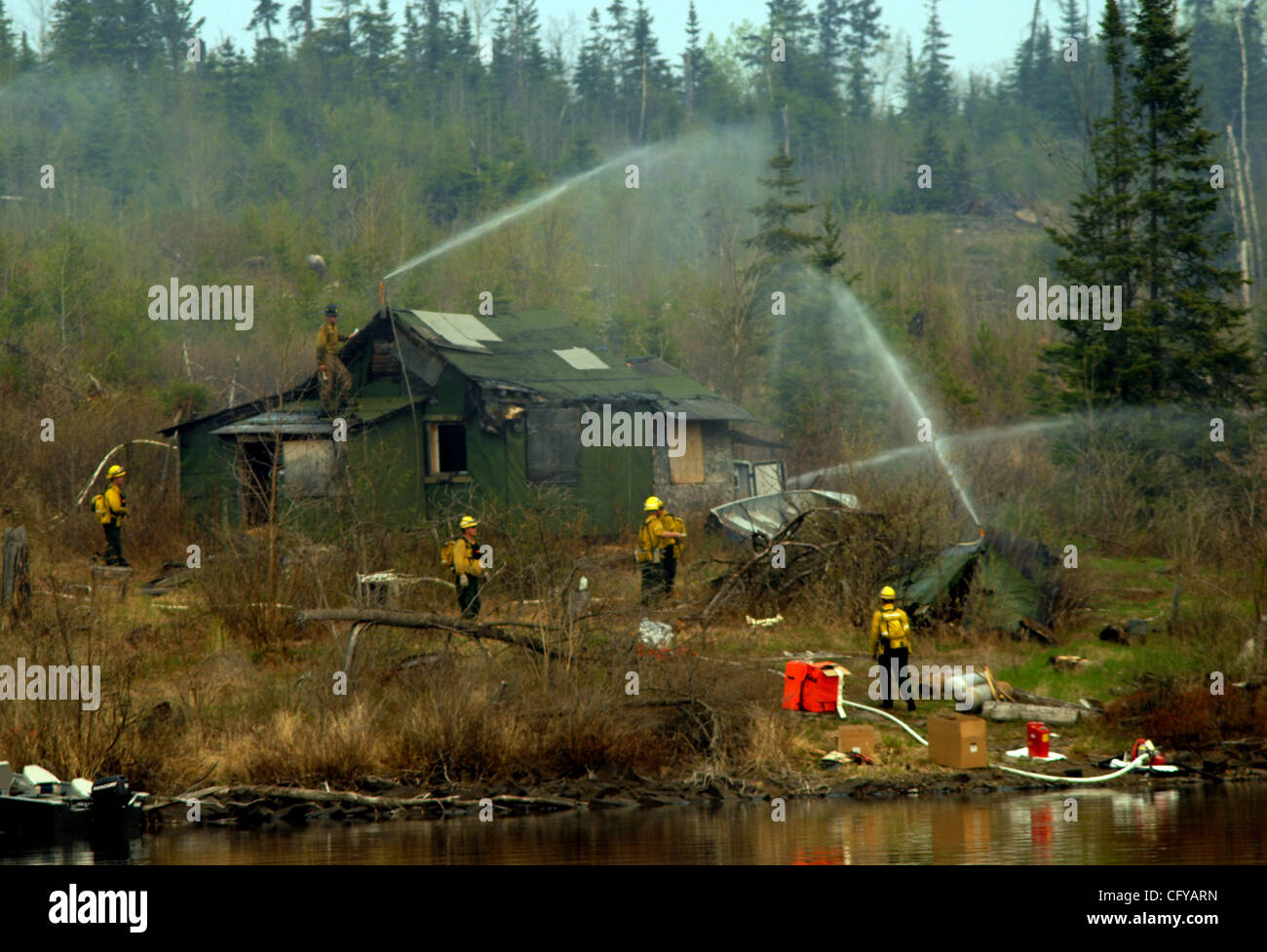 Gunflint Trail Wednesday, 5/9/2007.Minnesota Inter-agency Fire Center MIFC crew no 1 instals sprinklers to protect a house on Gunflint Lake . They were preparing for a prescibed burn  (Credit Image: © Minneapolis Star Tribune/ZUMA Press) Stock Photo