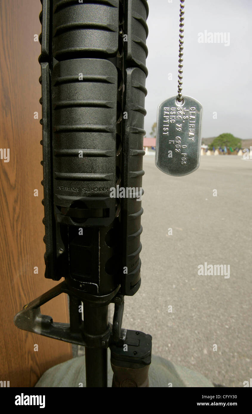 June 4, 2007, Camp Pendleton, California, USA Detail view of the military 'dog tag' of killed Marine Cpl. Jason Clairday hanging from a rifle positioned vertically with its bayonet placed in sand bags that also a Marine helmet on top of it. This was just in front of the speaker's podium at the speak Stock Photo
