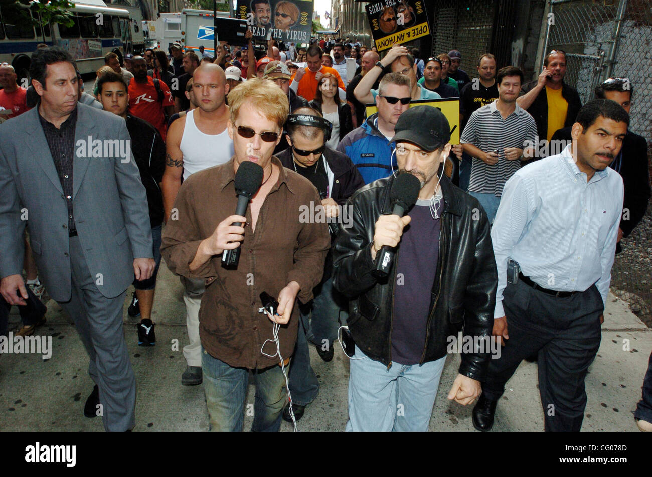 Radio personalities Gregg 'Opie' Hughes (R) and Anthony Cumia (L) walk from their morning shift at CBS Radio to theie home at XM Radio, resuming their live broadcasts of 'The Opie & Anthony Show' on XM. The duo served a 30-day suspension for a radio bit where a homeless man said he'd like to have vi Stock Photo