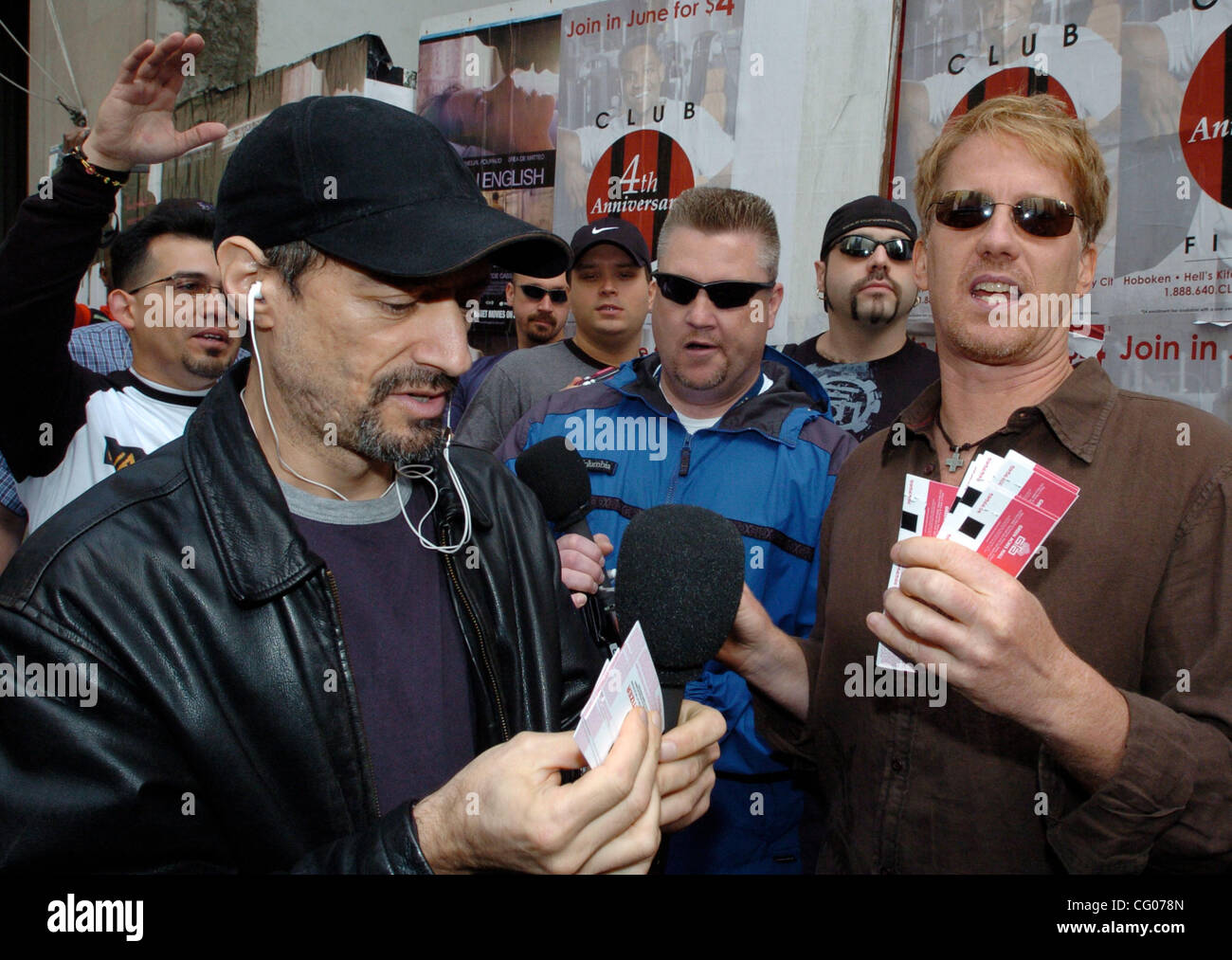 Radio personalities Gregg "Opie" Hughes (R) and Anthony Cumia (L) hand