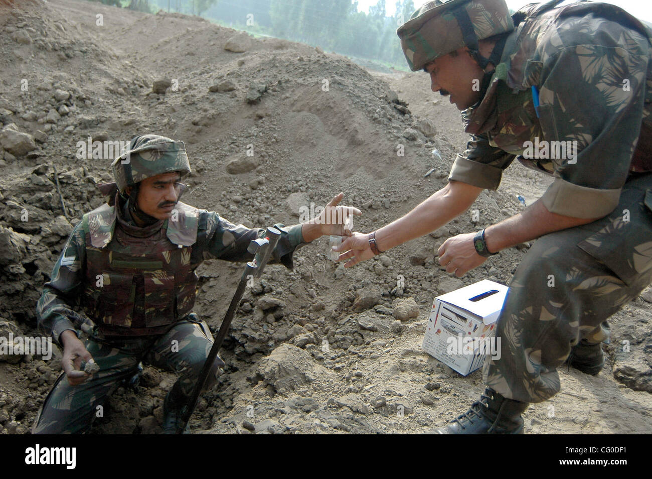 Jun 24, 2007 - Srinagar, Kashmir, India - An Indian Army soldier examines the site of an explosion in the outskirts of Srinagar, India, Sunday, June 24, 2007. At least ten personnel of the (SOG)special operation group of Jammu and Kashmir police were injured when a vehicle carrying them ran over an  Stock Photo