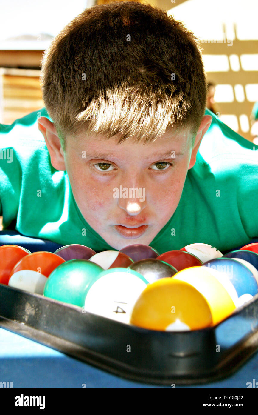 (Jay Solmonson/Tri-Valley Herald)  Joseph Pevsner, 14, from New York, racks up pool balls during a game with friends at Camp Wonder in Livermore. Stock Photo