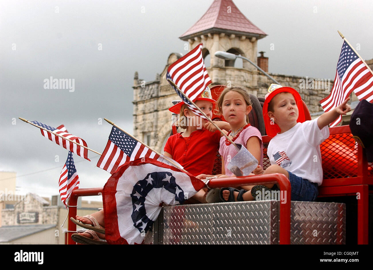 Jul 04, 2007 - Fredericksburg, TX, USA - Peyton Ives, 6, Sydney Ives, 5 and Jack Davis 4, ride on the Tierra Linda Volunteer Fire Department Truck during the Fredericksburg Fourth of July parade on Wednesday. (Credit Image: © Helen L. Montoya/San Antonio Express-News/ZUMA Press) RESTRICTIONS: US Tab Stock Photo