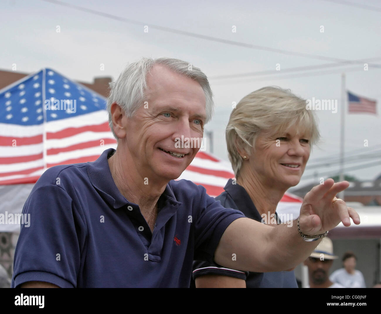 Democratic gubernatorial nominee STEVE BESHEAR (left) waved to supporters as his wife, JANE BESHEAR, looked on during a Fourth of July celebration parade on Main Street. A native of Dawson Springs, Steve has formerly held several elected offices, including lieutenant governor and state attorney gene Stock Photo