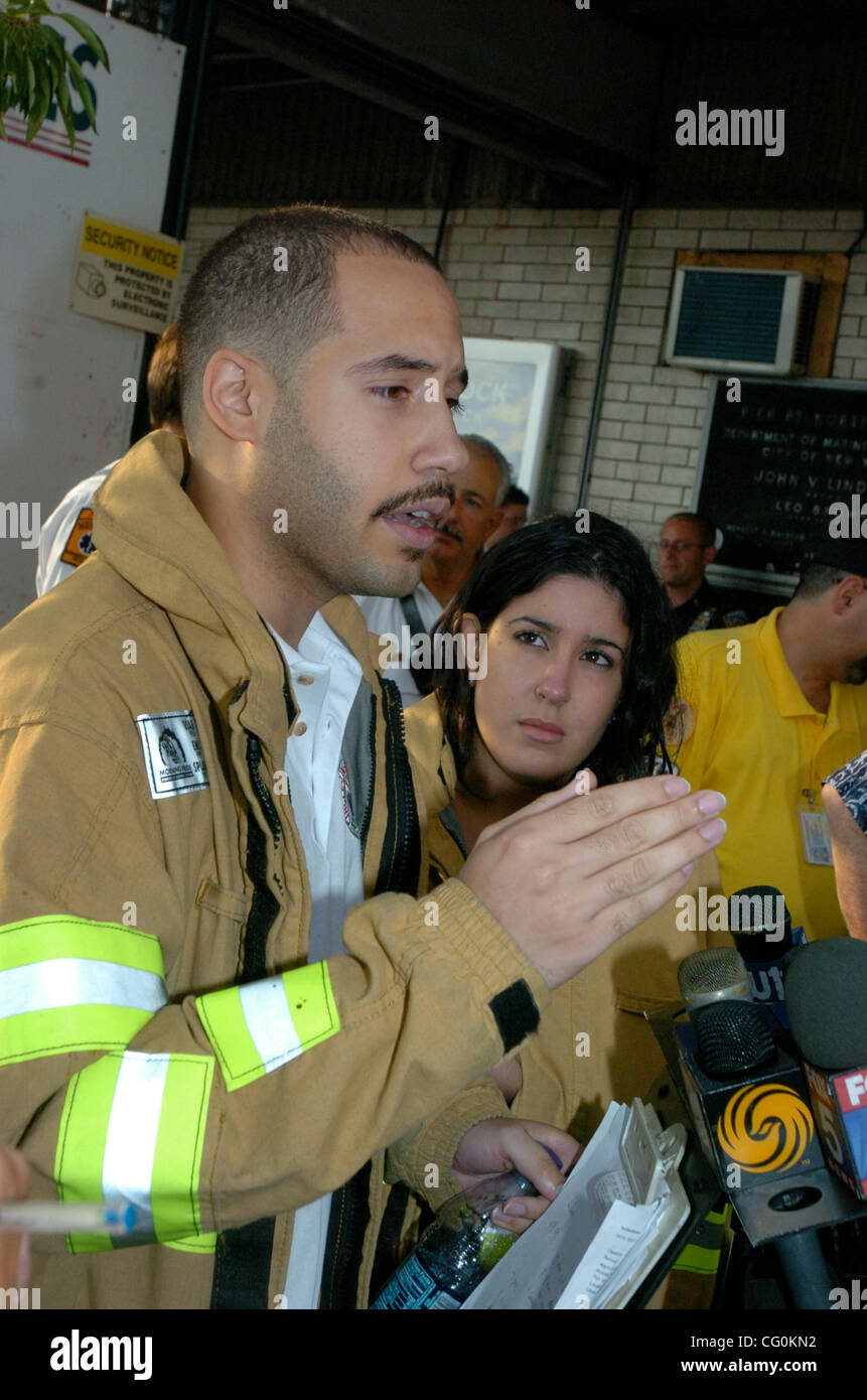 EMT Jose Mejia and girlfriend Zaira Machado speak to the press. A tourist helicopter splashed down in Hudson River near Weehawken, N.J., yesterday afternoon. None of the eight people aboard were injured. EMT Jose Mejia, 21 and his girlfriend Zaira Machado, 21 were in the sightseeing chopper they wer Stock Photo