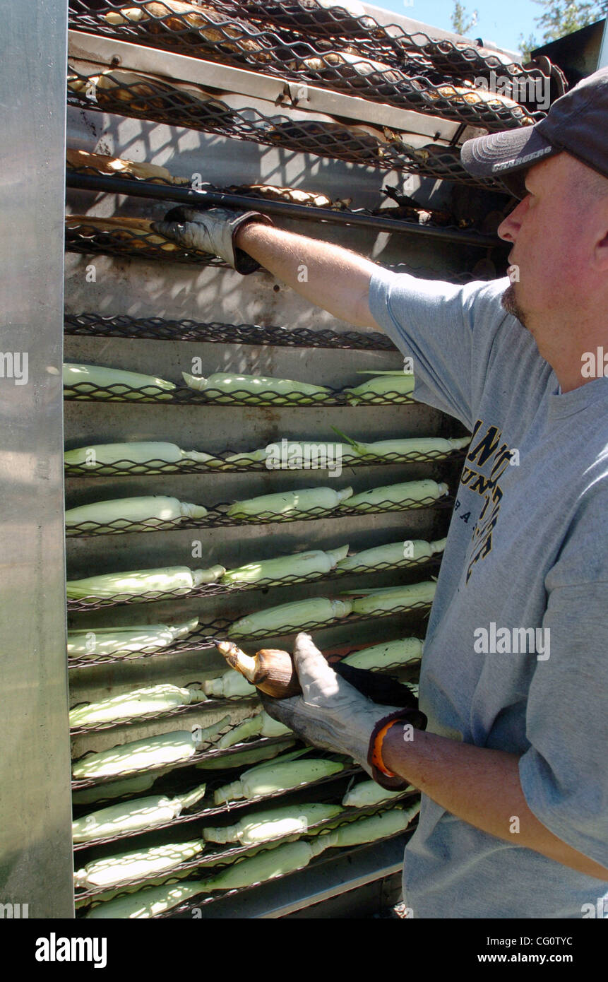 Trevor Beasley roasts corn in a 500 degrees oven during Cornfest in Brentwood, Calif. on