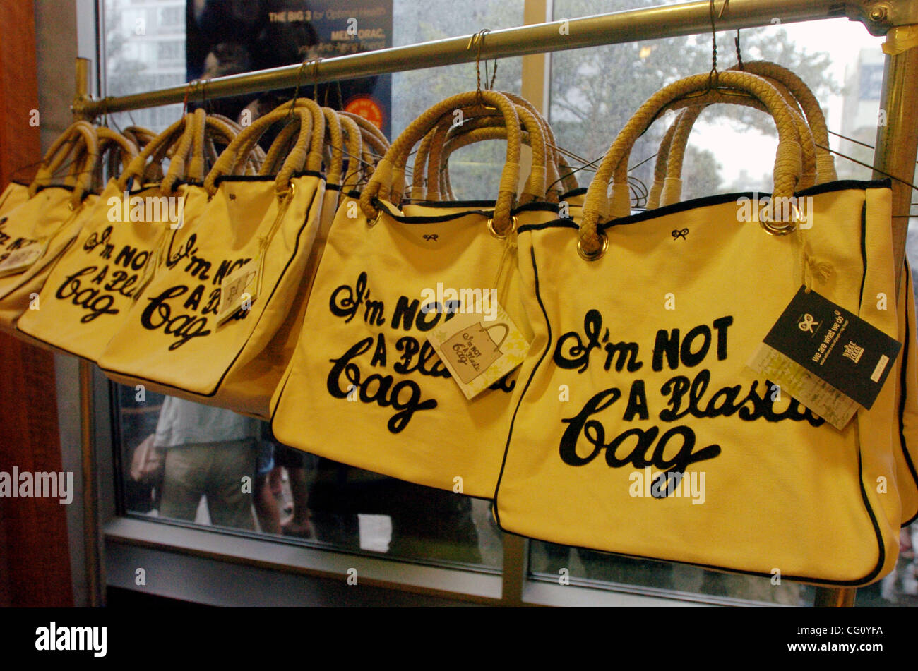 A rack of "I'm Not A Plastic Bag" totes. Thousands line up for Whole Foods Market launch of "I'm Not A Plastic Bag" shopping totes designed by Anya Hindmarch at select Whole Foods Markets in New York City. Designer Anya Hindmarch is on location at the Whole Foods Market Bowery for the New York City  Stock Photo