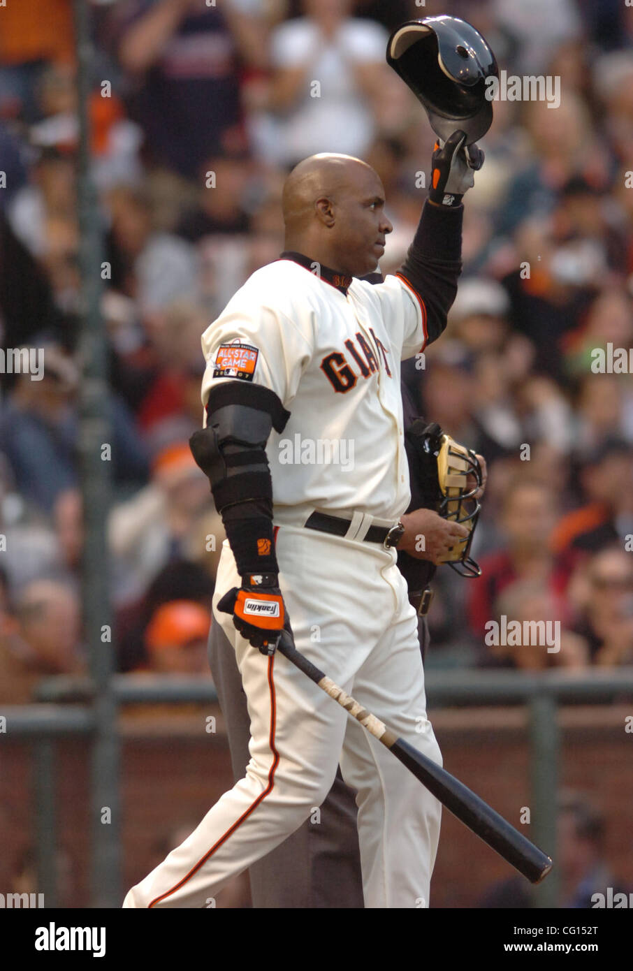 San Francisco Giants' Barry Bonds, foreground, takes some photos with a  camera as photographers record the event before his baseball game against  the Los Angeles Dodgers in Los Angeles on Saturday, April