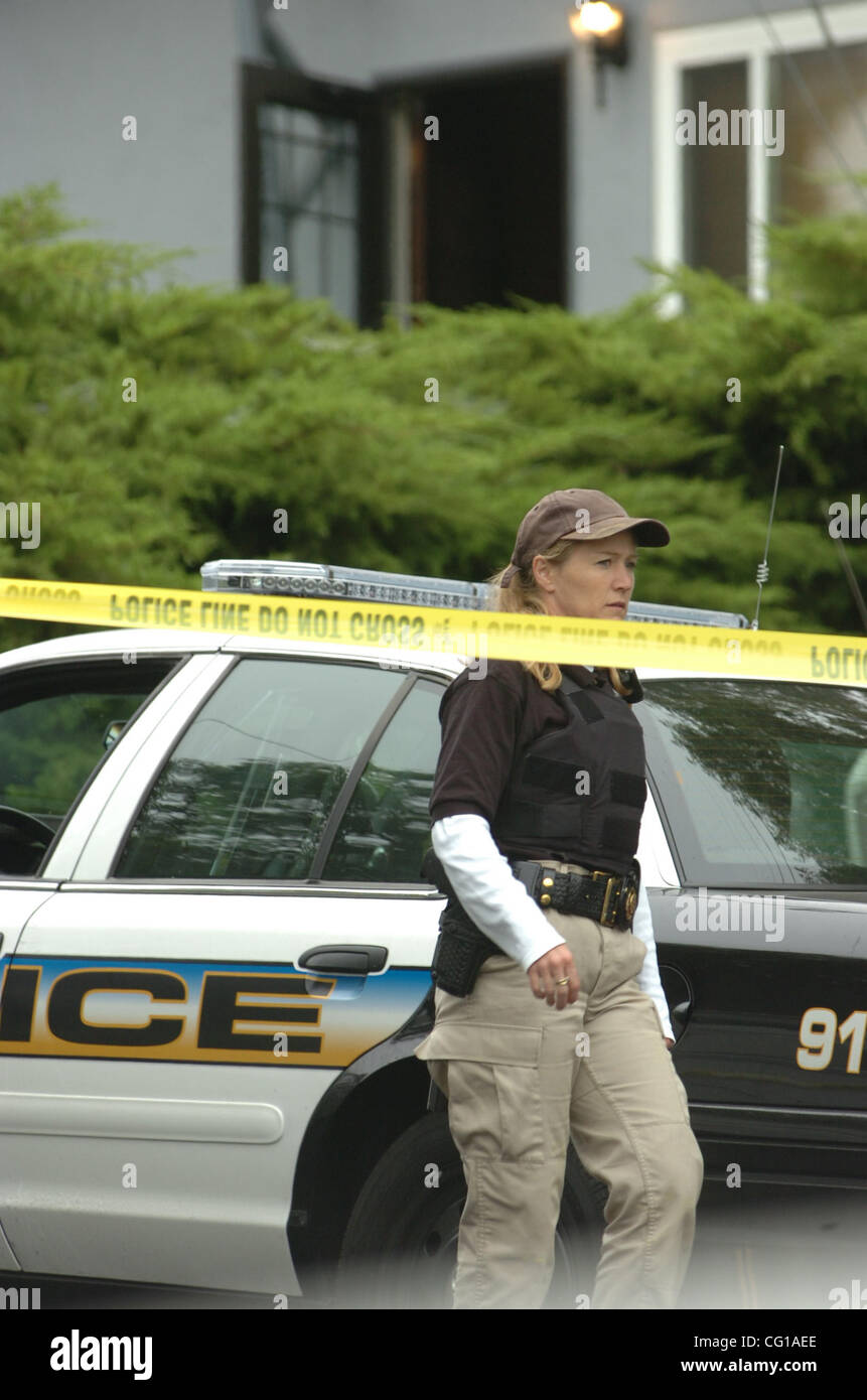 A Contra Costa County Sheriff's Department crime scene officer walks ...