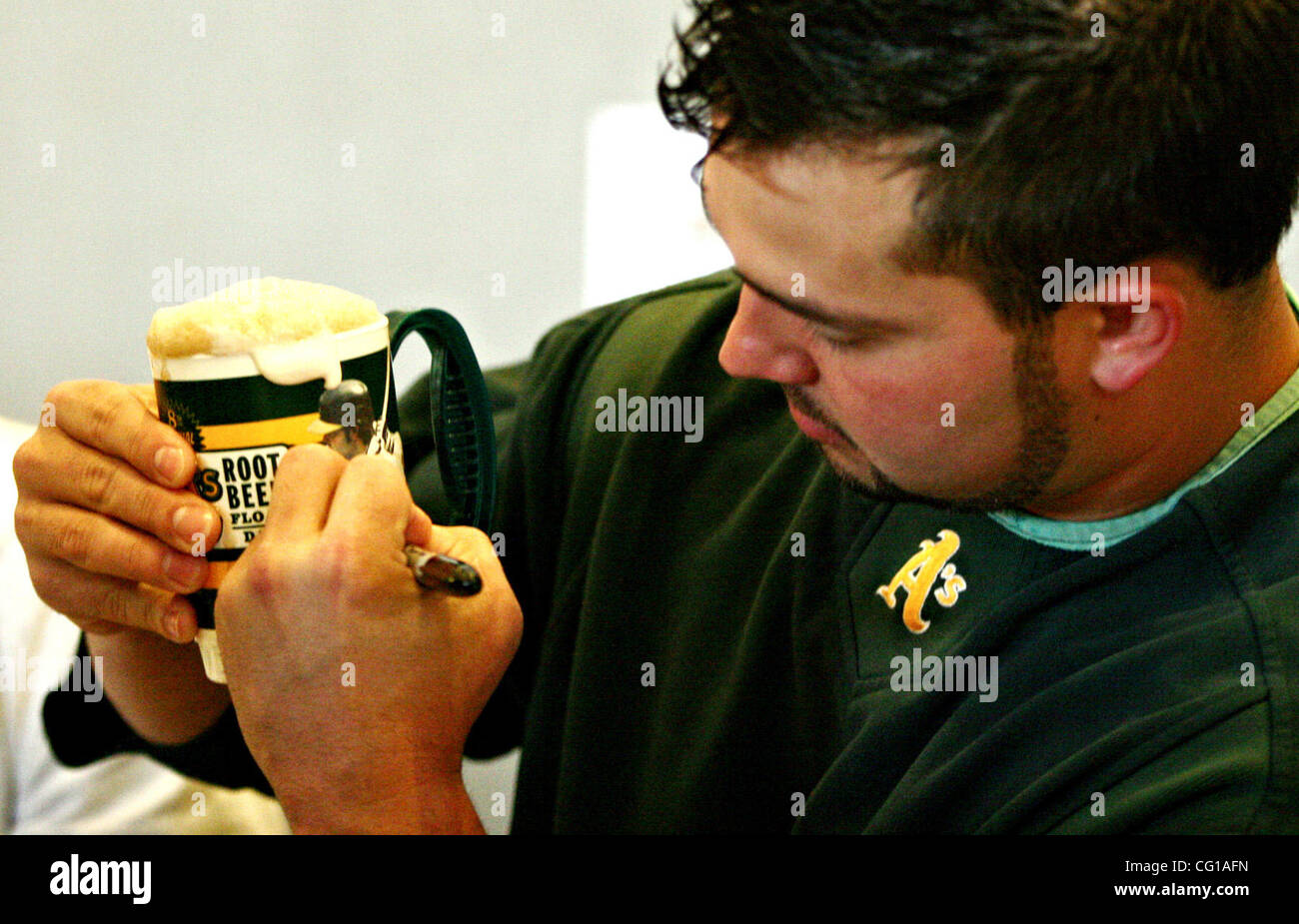 Oakland A's Nick Swisher autographs a mug at the 8th Annual MUG Root Beer Float Day to benefit the Juvenile Diabetes Research Foundation, at McAfee Coliseum, on Wednesday, August 1, 2007, in Oakland, California. (Anda Chu/The Fremont Argus) Stock Photo