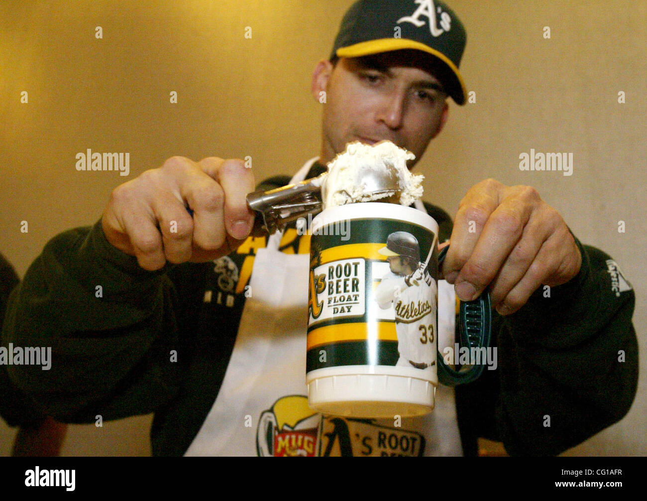 Oakland A's Marco Scutaro scoops up a root beer float at their 8th Annual MUG Root Beer Float Day to benefit the Juvenile Diabetes Research Foundation, at McAfee Coliseum, on Wednesday, August 1, 2007, in Oakland, California. (Anda Chu/The Fremont Argus) Stock Photo