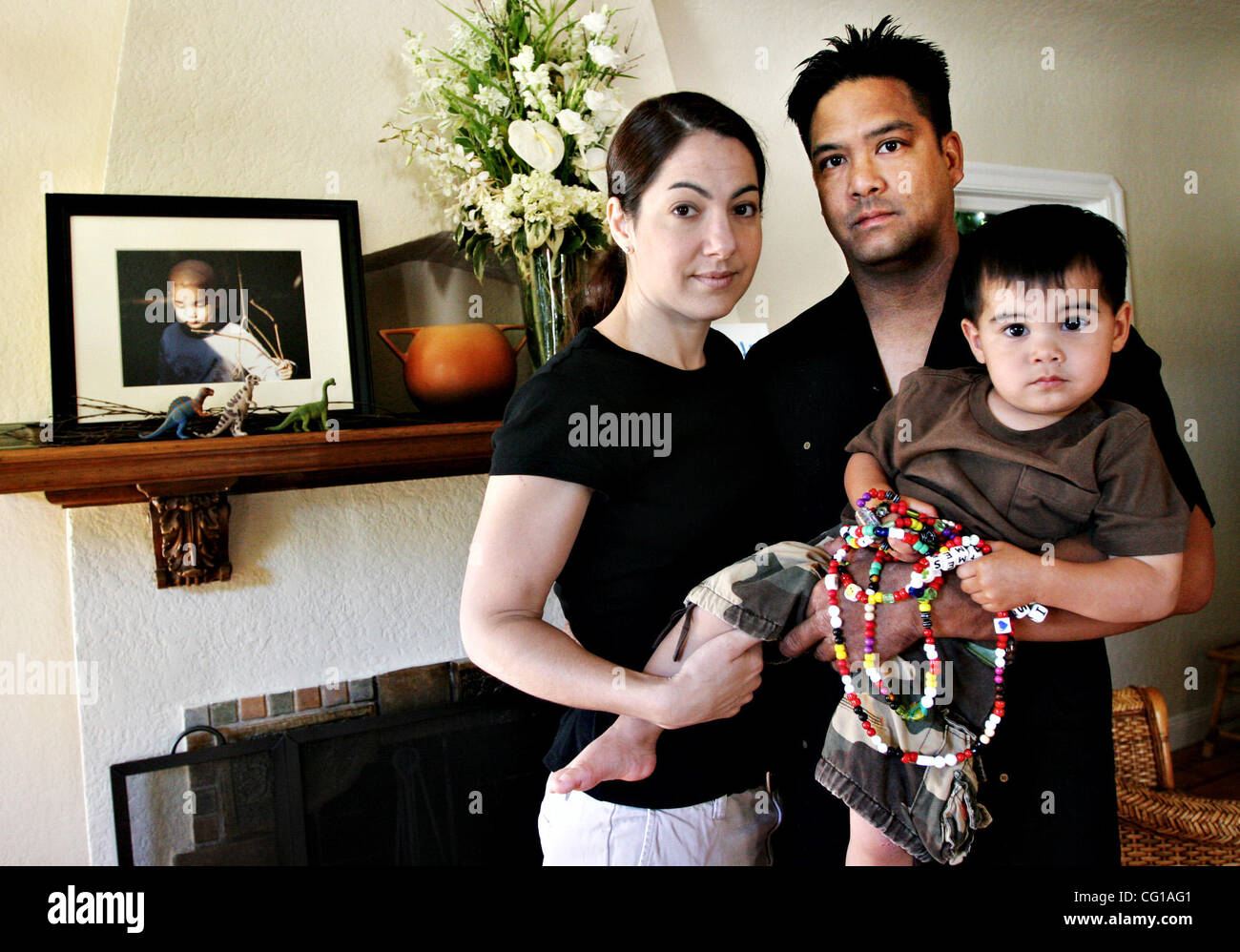 Stephanie Isaacson, O.J. Leonard and their son Lucas, 21 months, are pictured at their home on Wednesday, Aug. 1, 2007, in San Leandro, Calif. Their son Harrison, 2,  (in picture to the left) died July 16 from leukemia complications. Lucas is holding beads his brother received each time he received  Stock Photo