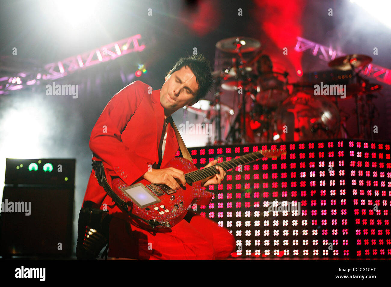 Muse performing at Madison Square Garden on August 6, 2007. Matthew Bellamy  on vocals in red suit Christopher Wolstenholme on bass Dominic Howard on  drums Photo Credit; Rahav Segev for The New