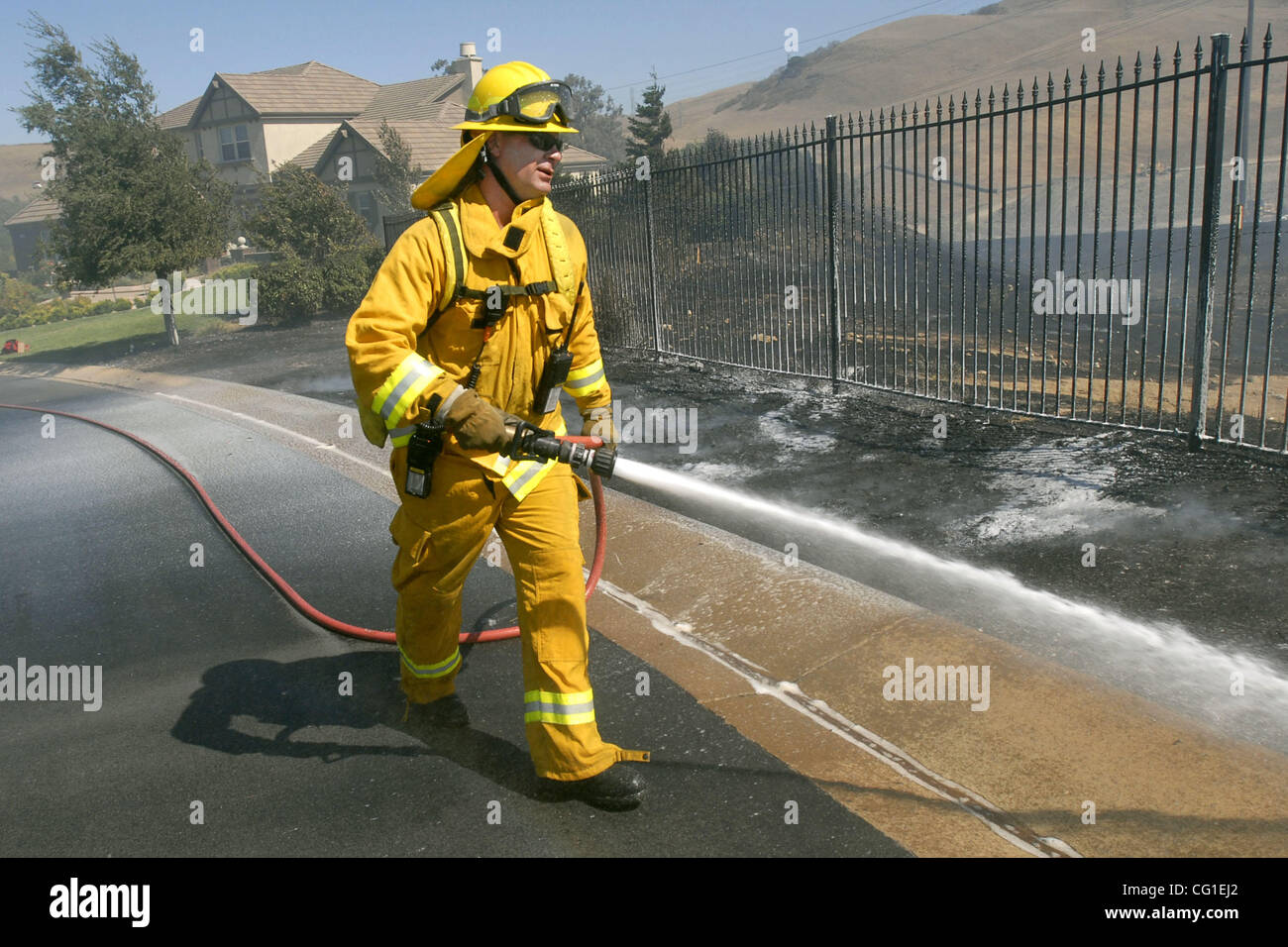 A Livermore/Pleasanton firefighter waters down hot spots on Campinia