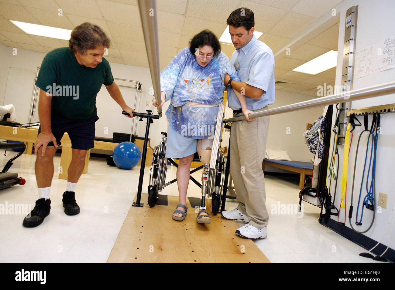 Aug 16, 2007 - Atlantis, FL, USA - Elissa Wehner walks on the parallel bars with the help of her physical therapist, Kenneth O' Sullivan, while her husband, Tom Wehner looks on.  Elissa Wehner goes to rehabilitative therapy at JFK hospital's outpatient facility on August 16, 2007. (Credit Image: © J Stock Photo