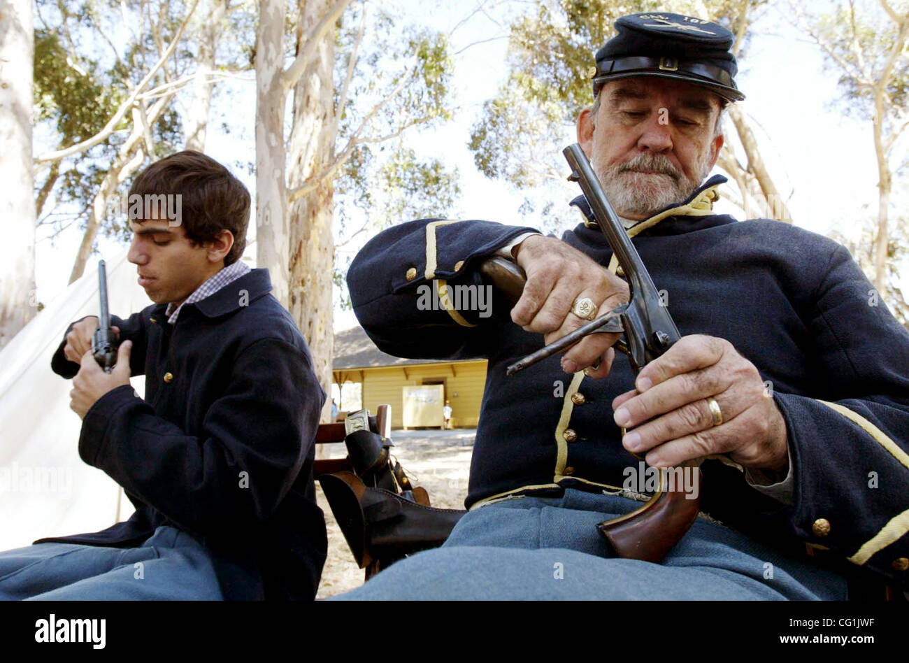 Union Army Civil War re-enactors Kevin Yarbrough, of Alameda, and Gil Hogue, of Sacramento, (LtoR) load their Colt Model 1860 Army revolvers in camp during Civil Wars Days, at Ardenwood Historic Farms, in Fremont, California, on Saturday August 18, 2007.  (Anda Chu/The Fremont Argus) Stock Photo