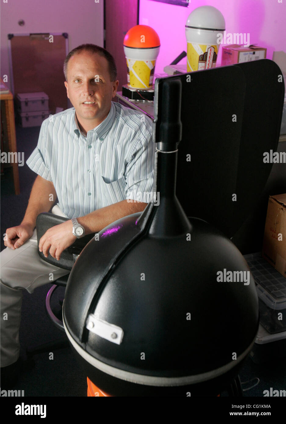 Aug 21, 2007, Oceanside, California, USA At left, ANDY SYBRANDY is the president  of Pacific Gyre.  At right is a 'surface sphere' which houses electronics, batteries, sensors and a transmitter.  These buoys have been deployed in the path of Hurricane Dean. The buoys gather data about ocean temperat Stock Photo