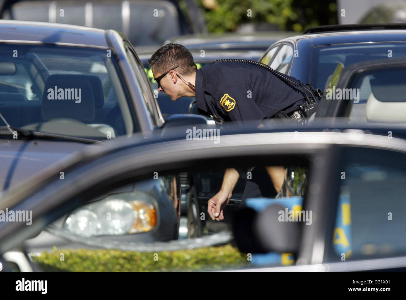 A Berkeley Police officer looks for a robbery suspect who ran away after  the speed chase ended on San Pablo Avenue near Solano Avenue in Albany,  Calif., on Friday Aug. 31, 2007.