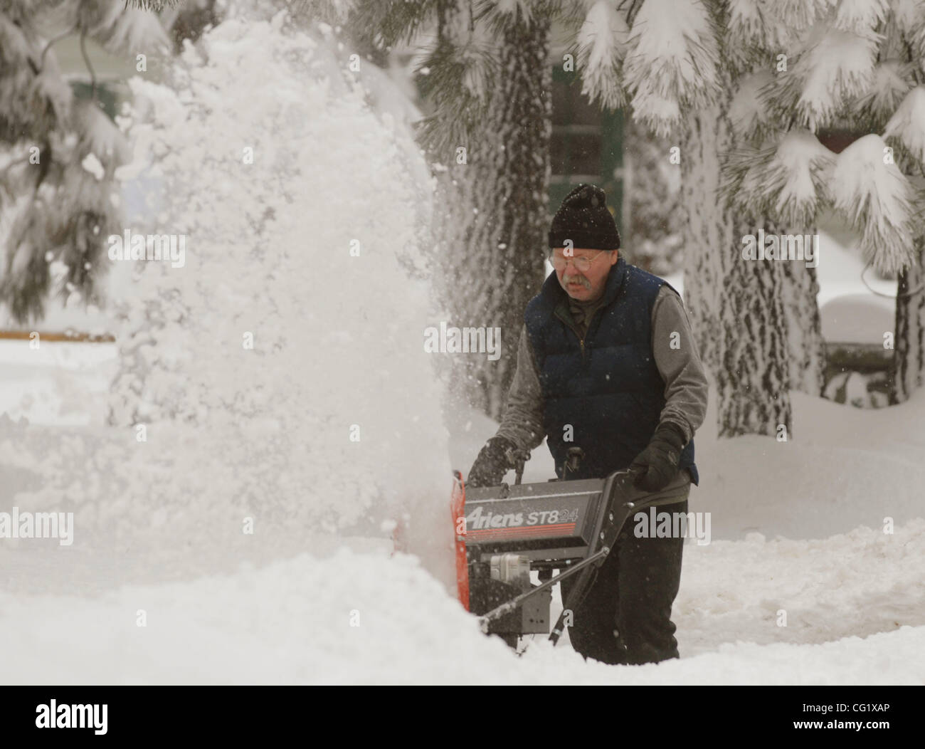 Ken Helseth digs his house out with a snow blower in South Lake Tahoe Calif., Saturday, January