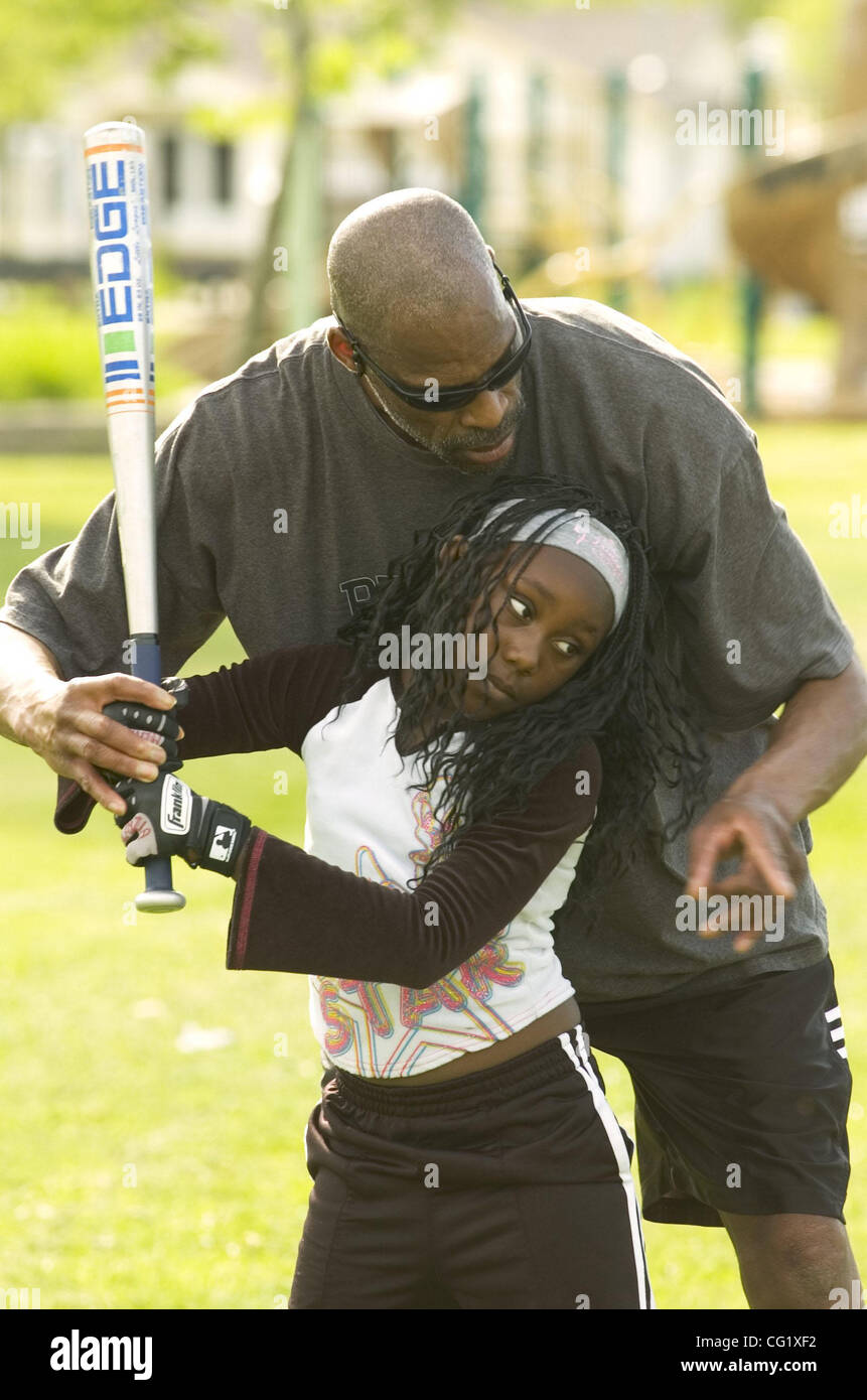 Cornell Gathing and his granddaughter, Alayzia Gathing, 9, practice softball in a park in April 2007. The Sacramento Bee/  Anne Chadwick Williams/  April 3, 2007 Stock Photo