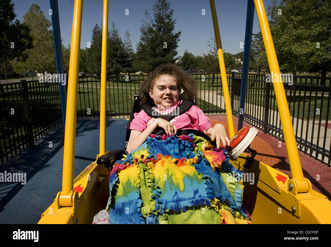 Jennifer Morgan, 20, of Elk Grove is shown the new handicap-accessible swing in a portrait taken at Margit & E. Henry Kloss Park August 8, 2007.  Morgan, who has Rett Syndrome, was the first person to use the swing.  The swing is the first on the west coast to be installed in a public park.  Sacrame Stock Photo