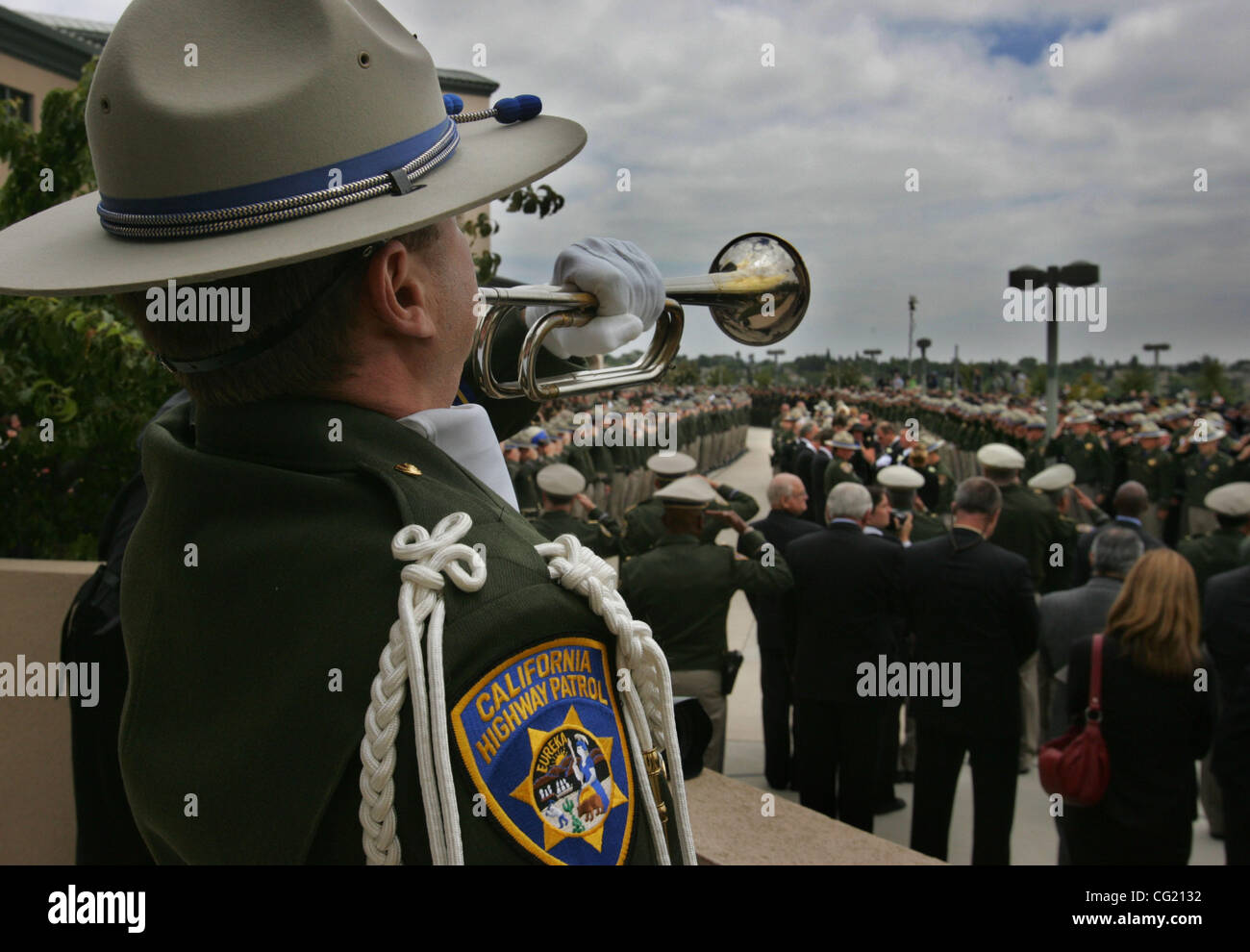 ONLINE CAPTION:  California Highway Patrol Officer Briar Segal plays taps as Officer Scott Russell's casket is wheeled from the church.  Sacramento Bee / Bryan Patrick   CHP officer Briar Segal (cq) (yes, it's Briar) plays taps as CHP officers and other officers from different agency's salute as the Stock Photo