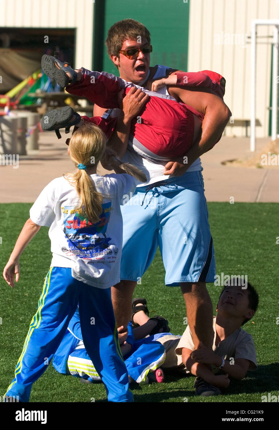 Summer Aquatic Camp counselor Paul Nederveld (cq) fends off a friendly attack from campers Thursday, June 7, 2007 before a sailing lesson at the CSUS Aquatic Center. From kayaking and canoeing to wind surfing and sailing, the center offers water safety and recreational activities to the public year  Stock Photo