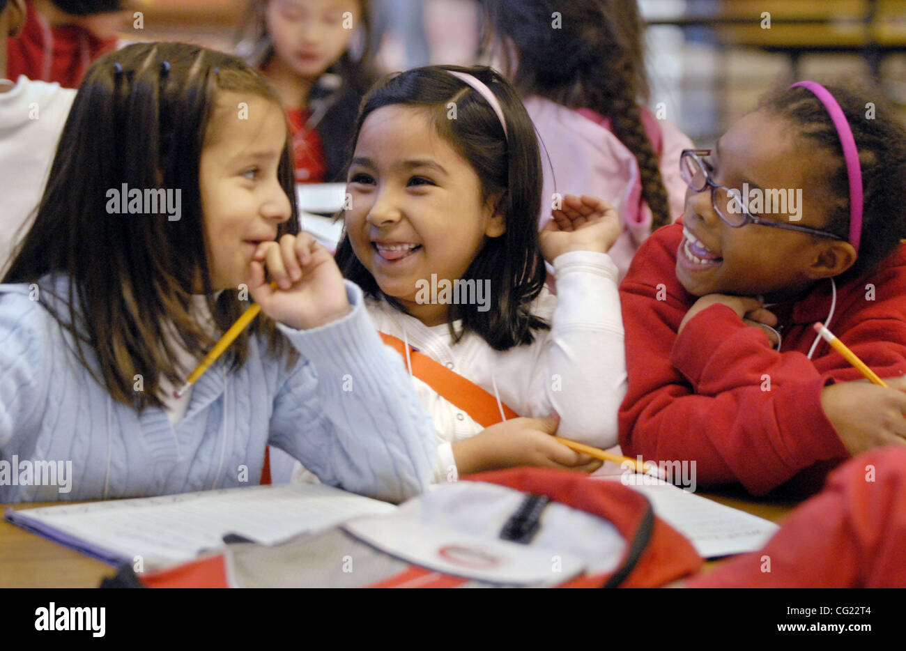 LEDE From left, Joanna Pardo-Lopez (cq), 6, Melissa Hernandez (cq), 6, and  Laniah Walker (cq), 6, share some laughs while doing their homework at  Camelia Basic Elementary School's new after school program,