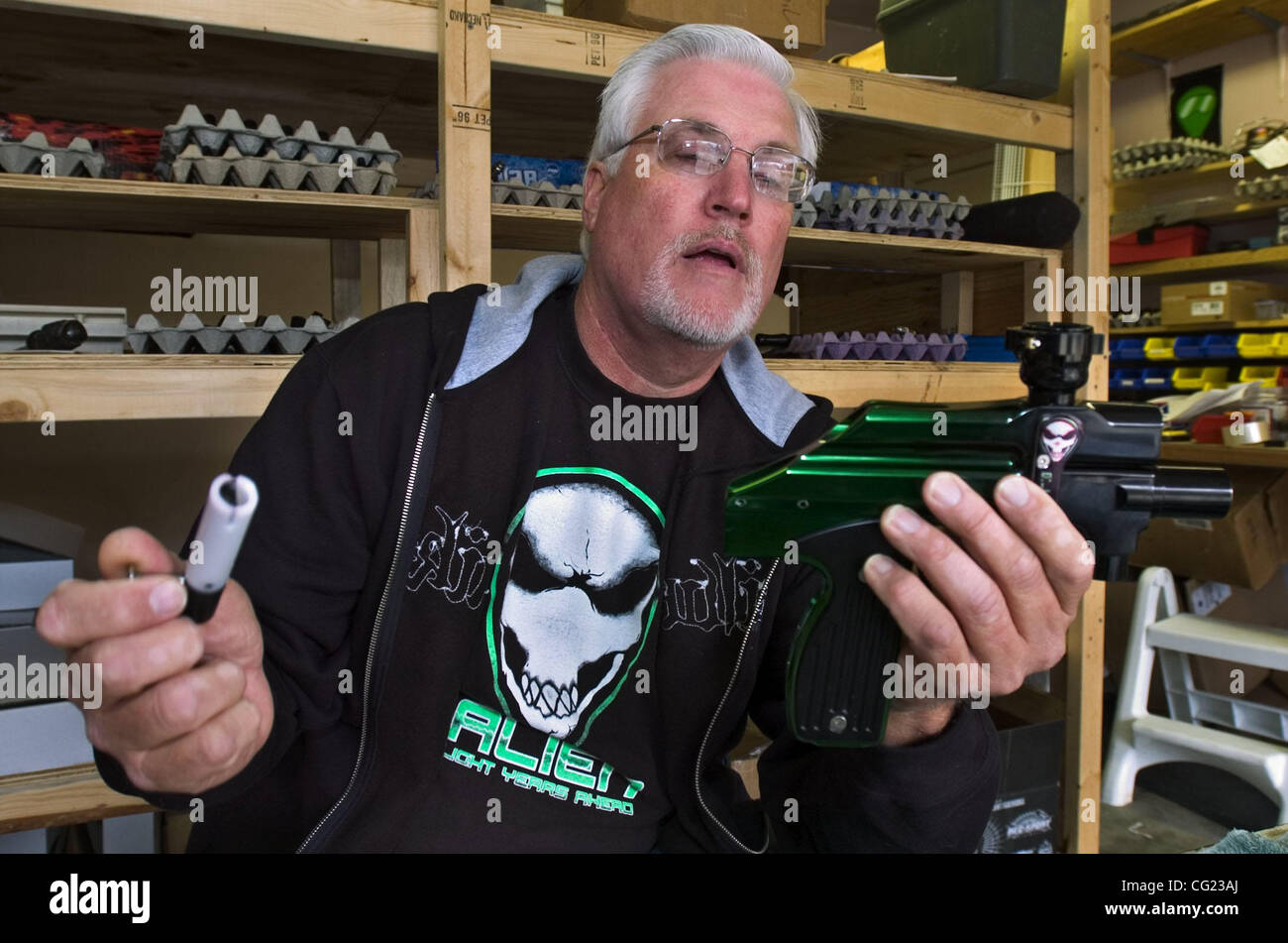 SECOND 2of4 Inventors:  Jack Rice <cq> got a patent last year for a rapid fire gun that fires paint ball capsules.  He holds the paint ball gun and a firing bolt as he works in his garage in Elk Grove.  Thursday, February 8, 2007.  Sacramento Bee/  Jay Mather inventor Stock Photo