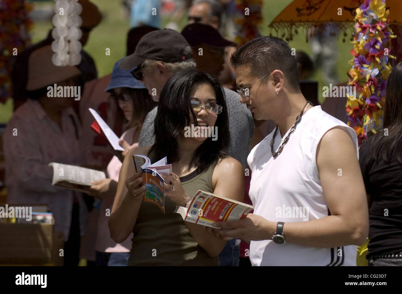 Kim and Maria Altamero (cq) of Sacramento look through the Tegalo English  translation books at the 16th Ati-Atihan Festival & Dance at the Jose Rizal  Community Center on Sunday afternoon in Sacramento.