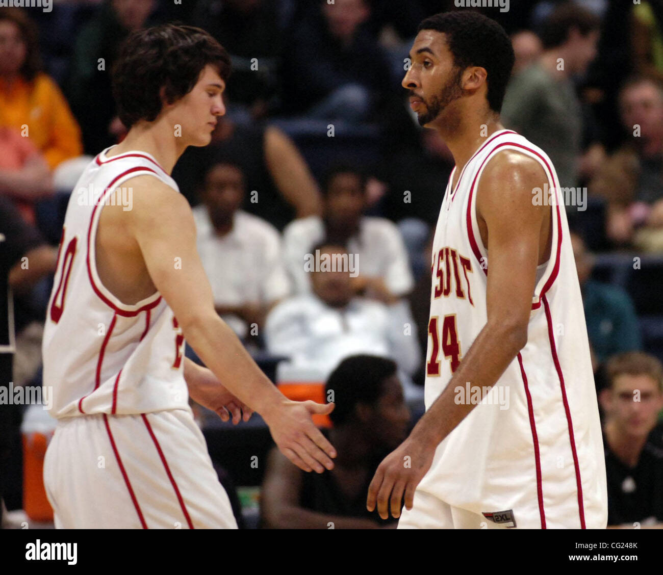 Kyle Harvey, #20, of Jesuit High School, greets teammate James Edwards,  #14, after James was pulled out of the game in during Jesuits 77 to 64 loss  at Stockton Arena during the