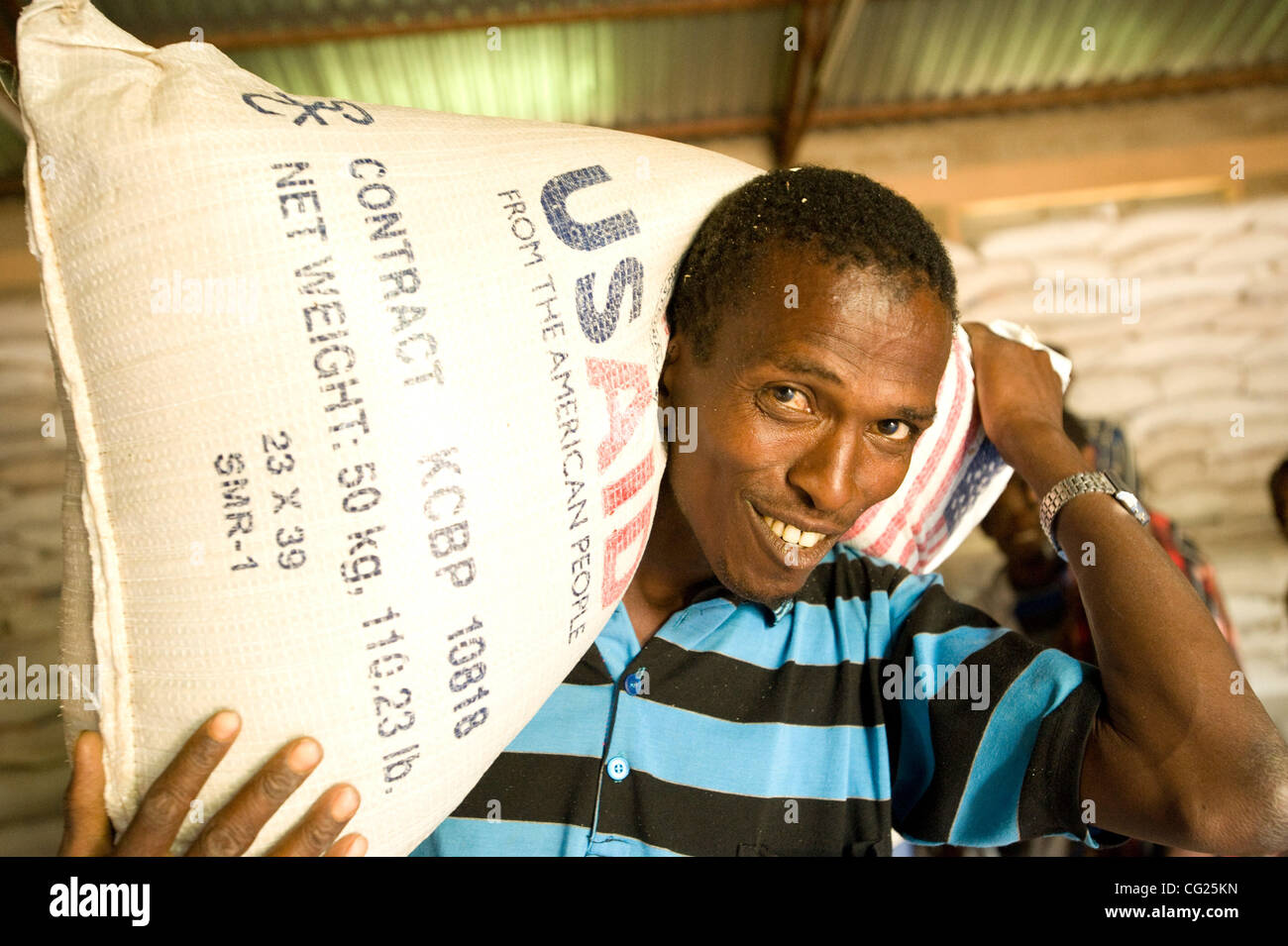 July 27, 2011 - East Hararghe Zone, Ethiopia - July 27, 2011, Chelenko, Ethiopia - Day laborers, paid with food, help load 110 pound bags of wheat and dried split peas for a food distribution in the town of Chelenko in the East Hararghe Zone. 11 million people are receiving food in Ethiopia, nearly  Stock Photo