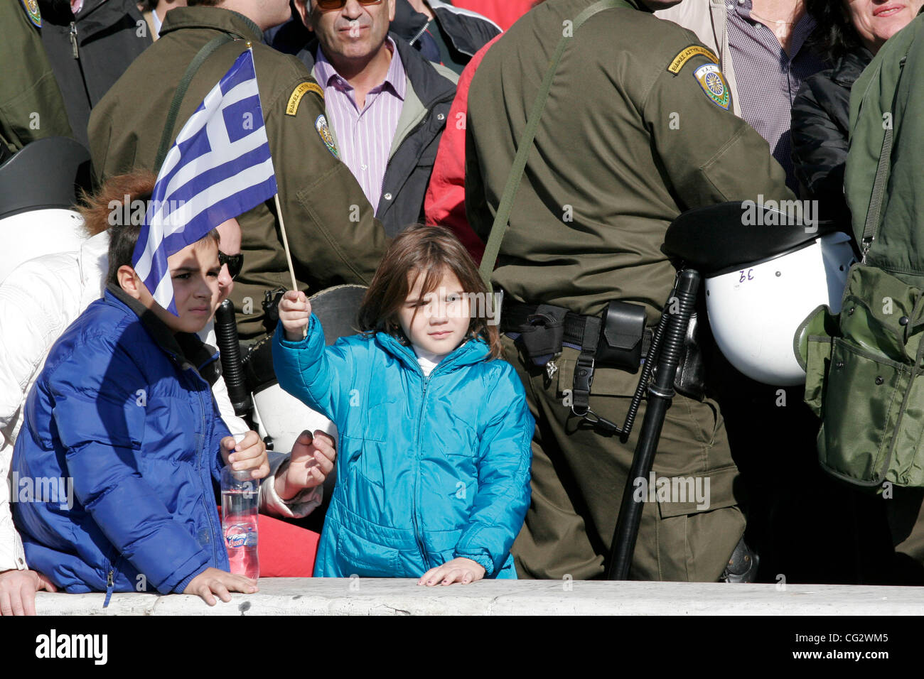 Oct. 28, 2011 - Athens, Greece - A child holds the Greek flag among the riot police. Protest during student parade for the 71st anniversary of Greece's entry into World War II in front of Education Minister Anna Diamantopoulou outside  the Greek Parliament. (Credit Image: © Aristidis Vafeiadakis/ZUM Stock Photo