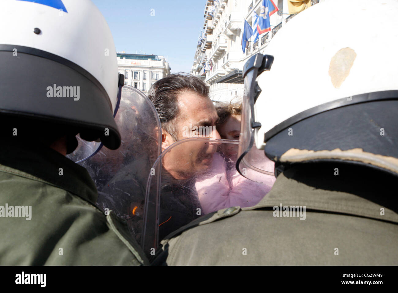 Oct. 28, 2011 - Athens, Greece - A protester holds his terrified child among the riot police. Protest during student parade for the 71st anniversary of Greece's entry into World War II in front of Education Minister Anna Diamantopoulou outside  the Greek Parliament. (Credit Image: © Aristidis Vafeia Stock Photo