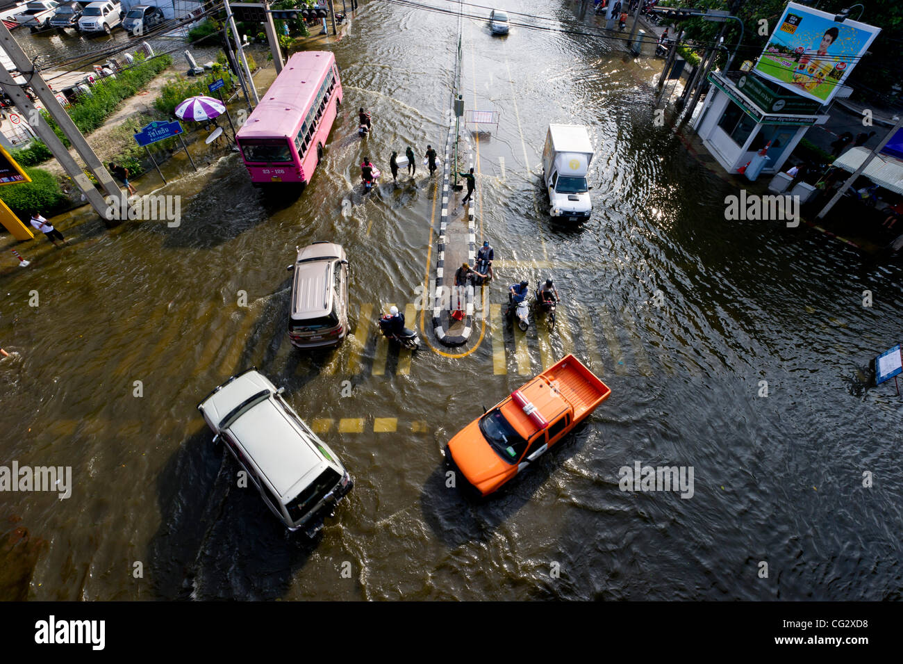 Nov. 4, 2011 - Bangkok, Thailand - People drive and walk through floodwaters as they creep further into the center of the city. Thailand is suffering from it's worst flooding in 50 years. Around 430 people have died since late July according to Department of Disaster Prevention and Mitigation. (Cred Stock Photo