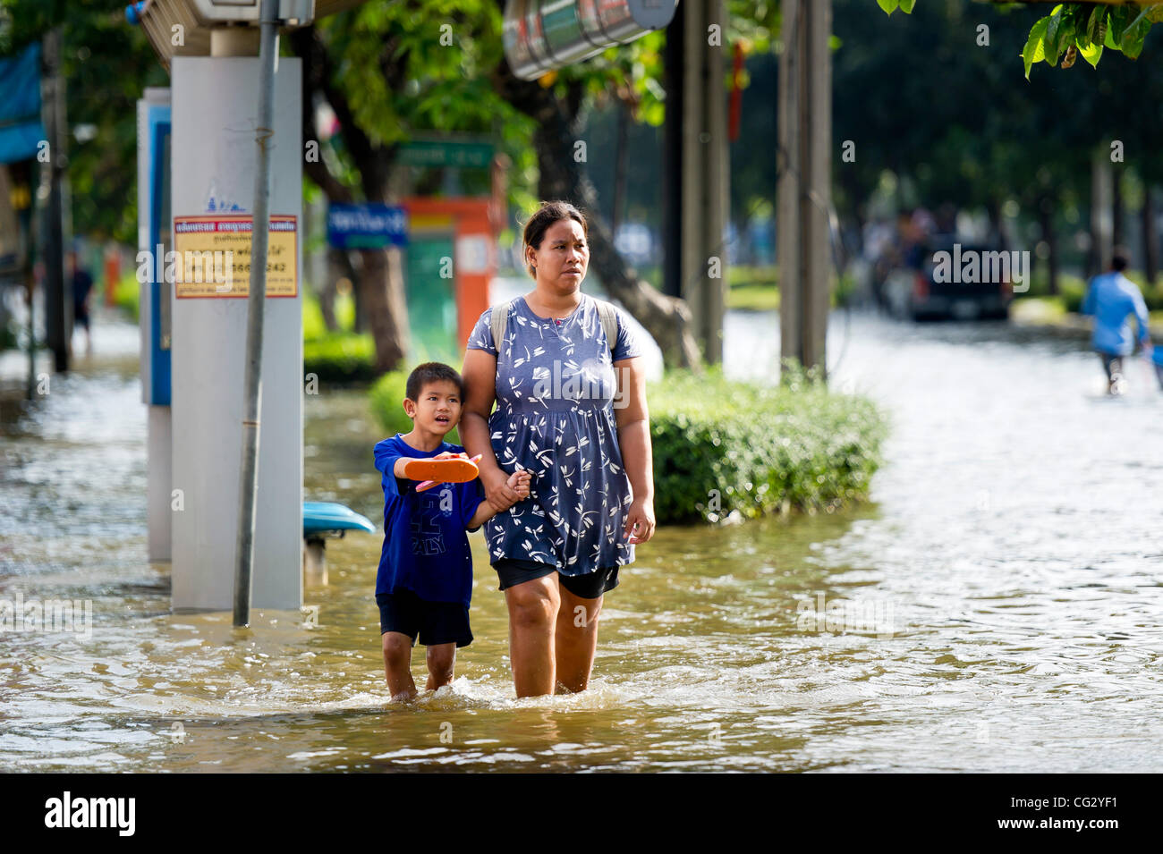 Nov. 10, 2011 - Bangkok, Thailand - Thai residents wade through floodwaters in Bangkok, Thailand. Floodwaters are creeping further into city's center. Thailand is suffering from worst flooding in 50 years. Over 400 people have died due to flooding since late July according to Department of Disaster  Stock Photo