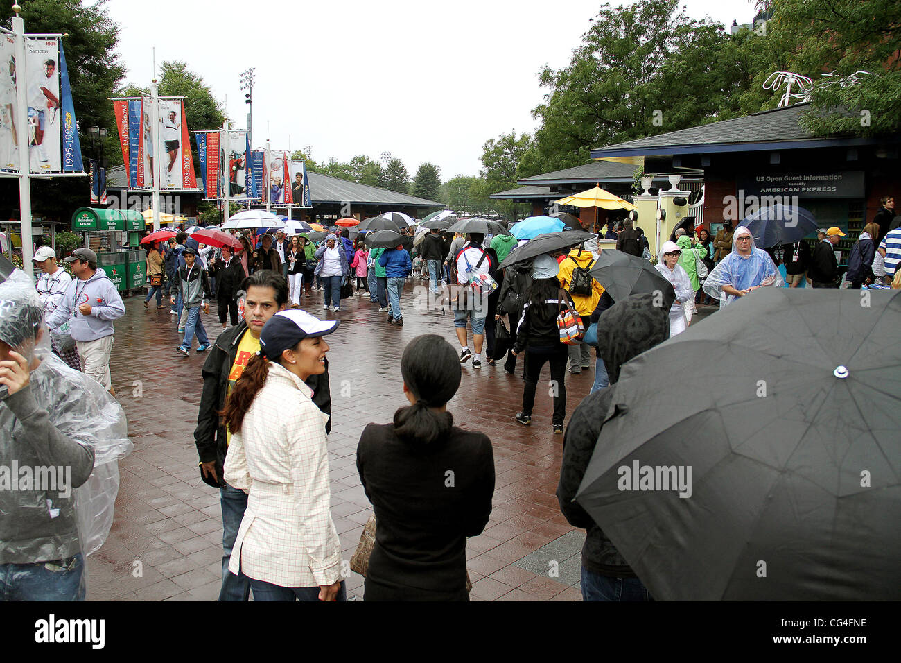 Fans brave the rain at the USTA Arthur Ashe Stadium in Flushing, Queens. The US Open men's tennis final championship match between top-seeded Rafael Nadal and third-seeded Novak Djokovic has been rescheduled at 4 p.m. on Monday, 13 September, because of r Stock Photo