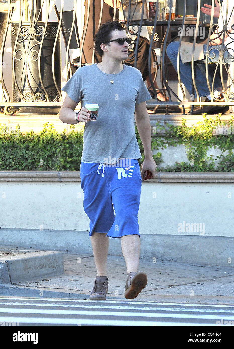 Orlando Bloom in long blue shorts and 