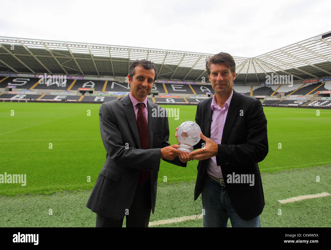 Pictured L-R: Sky Sports presenter John Phillips presenting the F&C Investments League Managers Association  (LMA)performance of the week award to manager Michael Laudrup, for his team's performance against Queens Park Rangers. Thursday 23 August 2012  Re: Barclay's Premier League side Swansea City FC press conference at the Liberty Stadium, south Wales, UK. Stock Photo