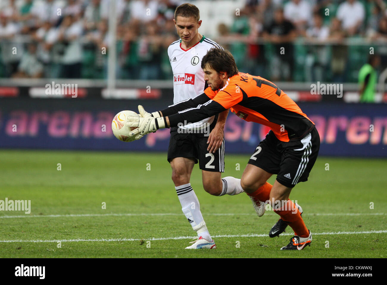 23rd Aug 2012. 23.08.2012. Warsaw, Poland.  Europa League Football Legia Warsaw v Rosenborg .  ARTUR JEDRZEJCZYK saves in front of DUSAN KUCIAK (LEGIA) The game ended in a 1-1 draw. Credit:  Action Plus Sports Images / Alamy Live News Stock Photo