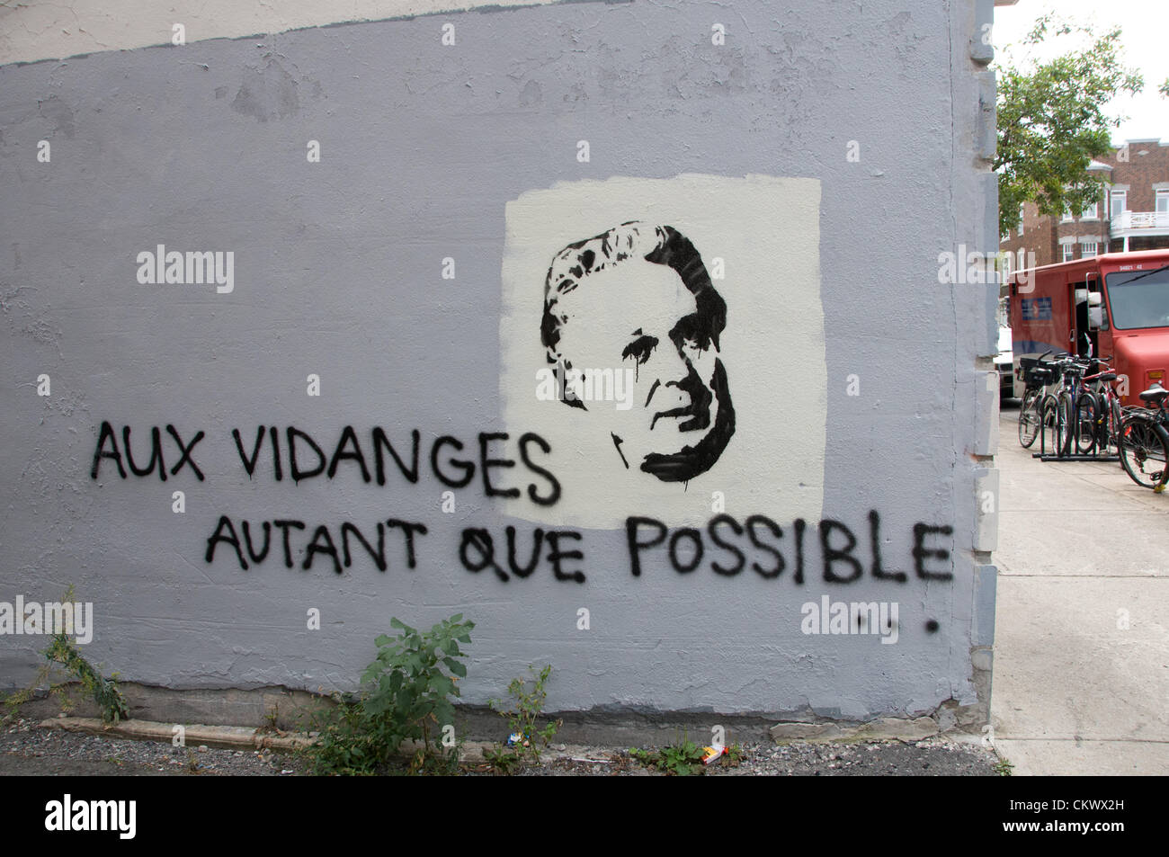 This montreal anti current government mural depicts Quebec's Prime Minister Jean Charest and a slogan saying : In the garbage as much  as possible Stock Photo