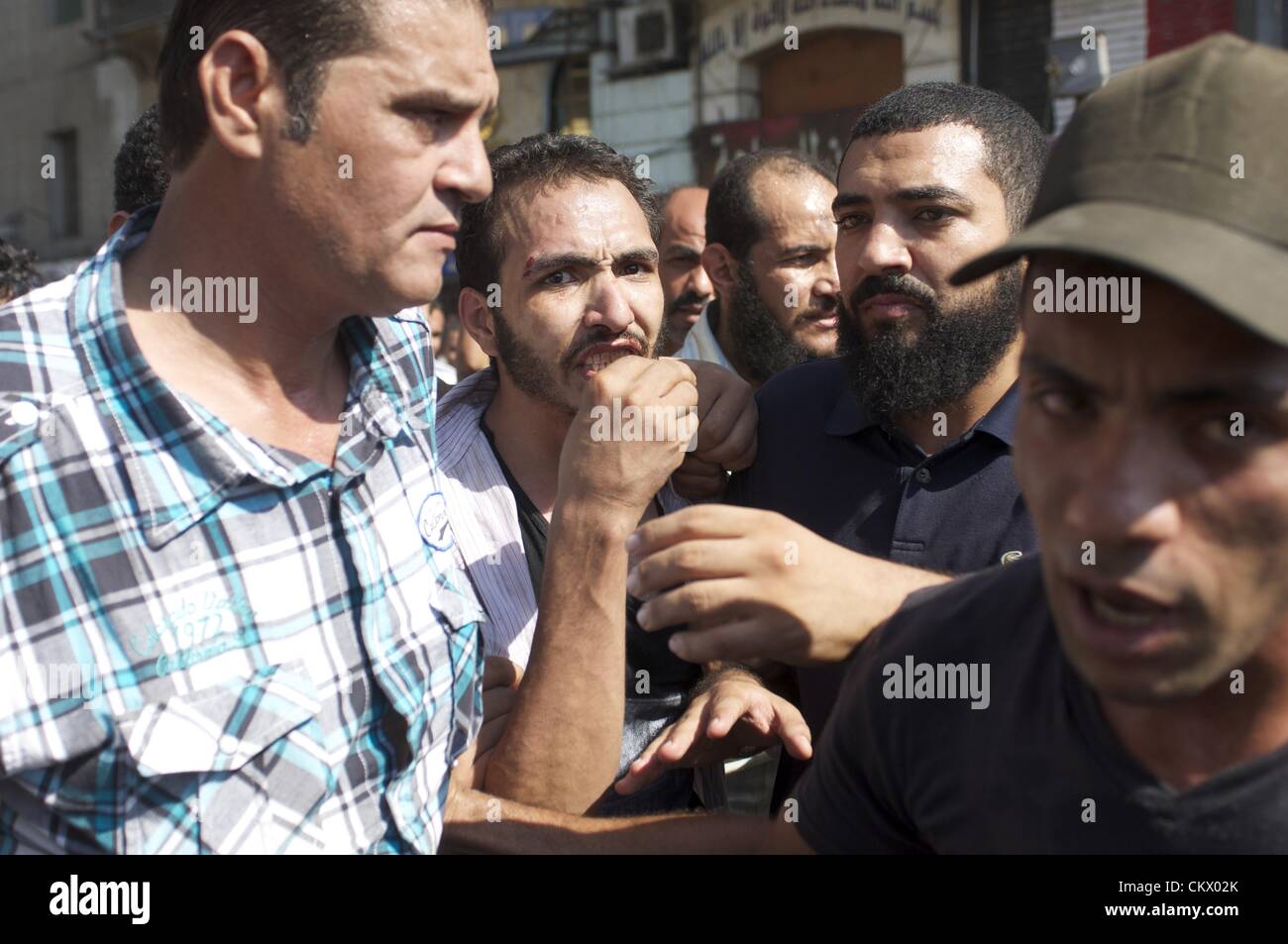 Aug. 24, 2012 - Cairo, Egypt - A man is cared for as supporters and opponents of Egyptian President's Muslim Brotherhood Government clash in downtown Cairo. Anti-Muslim Brotherhood protesters called for a second revolution and plan protests in several areas of the city. (Credit Image: © Cliff Cheney/ZUMAPRESS.com/Alamy Live News) Stock Photo