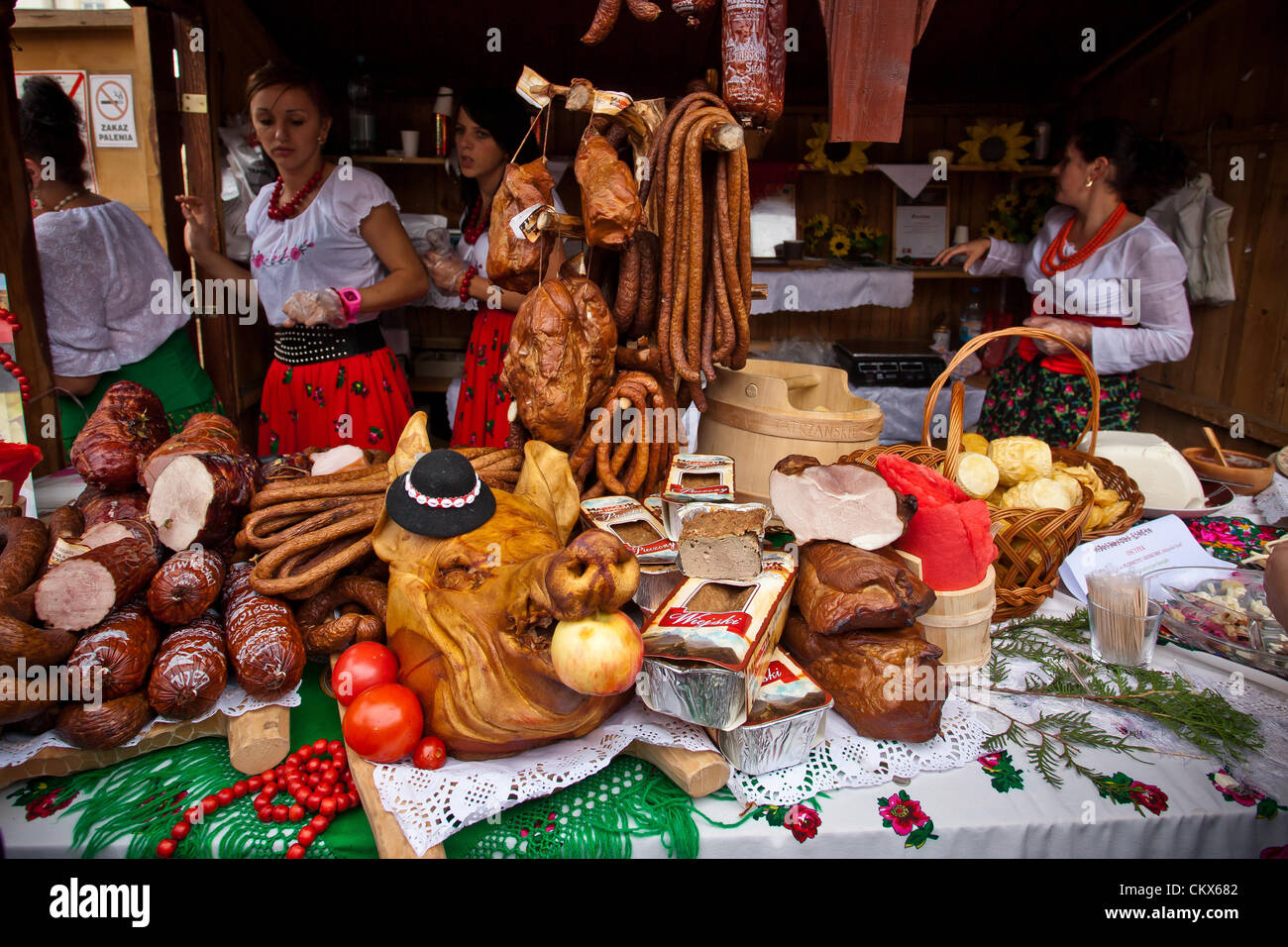 August 26, 2012 Cracow, Poland - Market stall with sausages and meats during annual traditional Polish food festival. Shown sausage (pol. - kiełbasa) is a food usually made from ground meat with a skin around it. Sausage making is a traditional food preservation technique. Sausages may be preserved by curing, drying, or smoking. Stock Photo