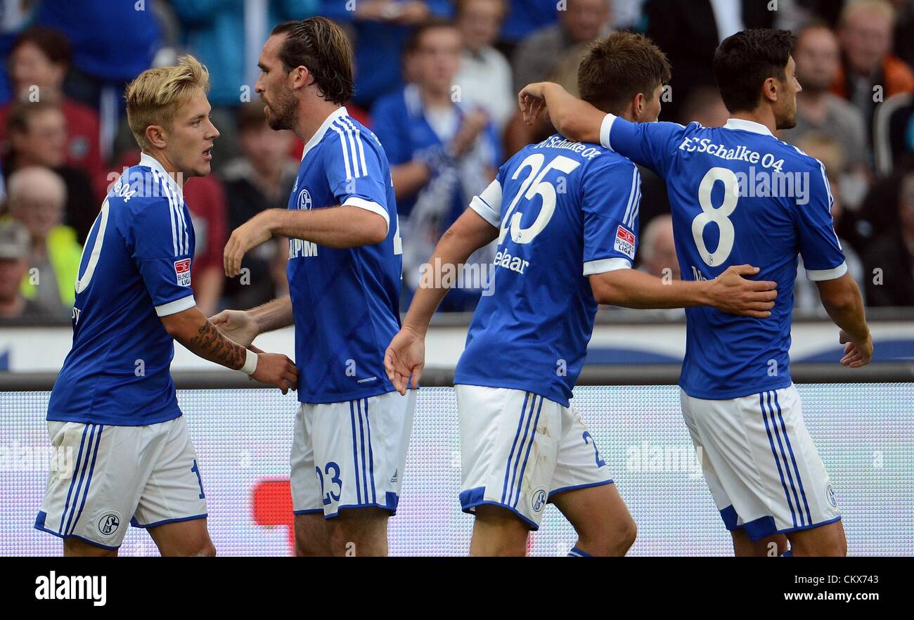 26 August 2012. Hanover, Germany.  Schalke's Klaas-Jan Huntelaar (3-L) celebrates his 1-1 goal with Lewis Holtby (L), Christian Fuchs and Ciprian Marica (R) during the Bundesliga soccer match between Hanover 96 and FC Schalke 04 at AWD-Arena in Hanover, Germany. Stock Photo
