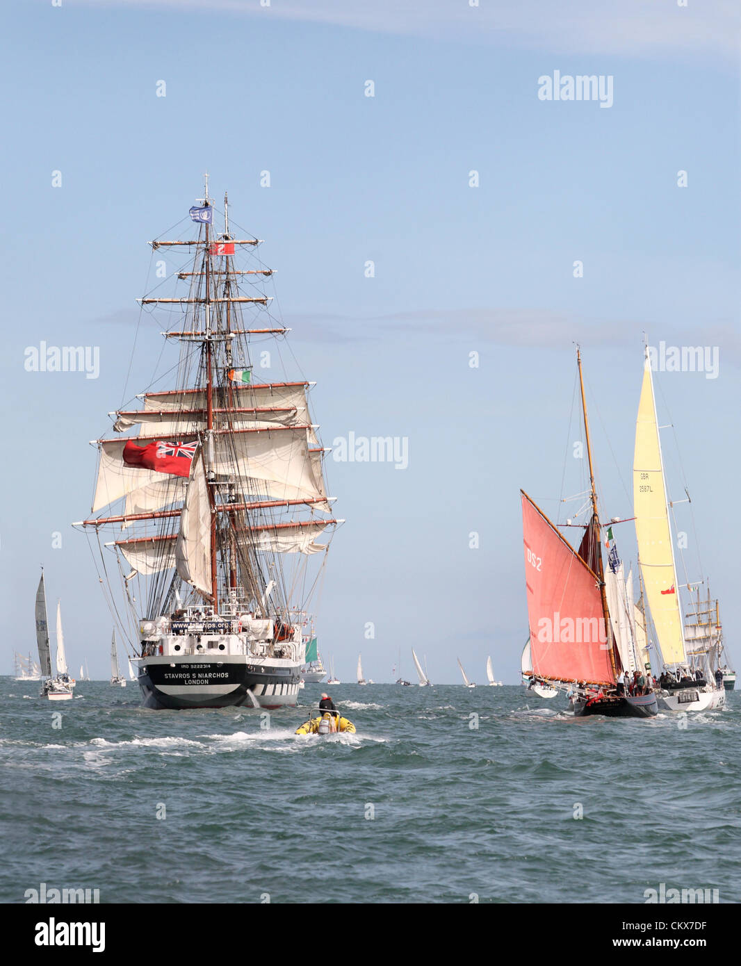 26th Aug 2012. After three days in port finally the tall ships have a tremendous send off as they leave Dublin Bay, over one million people lined the quayside in Dublin over three days while hundreds of pleasure craft gathered in the bay to escort the ships as they paraded along the coast. Pictured are the Stavros S Niarchos and the Jolie Brise (red sail) Credit:  Ian Shipley SHPS / Alamy Live News Stock Photo