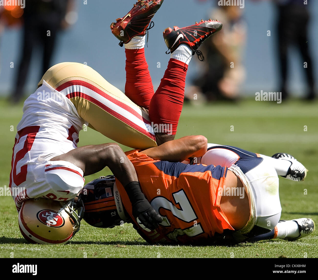 Aug. 26, 2012 - Denver, CO, USA - Broncos WR MATTHEW WILLIS, right, gets up ended by 49ers CB TRAMAINE BROCK, left, during the 1st. half at Sports Authority Field at Mile High Sunday afternoon. The Broncos lose to the the 49ers 29-24. (Credit Image: © Hector Acevedo/ZUMAPRESS.com) Stock Photo