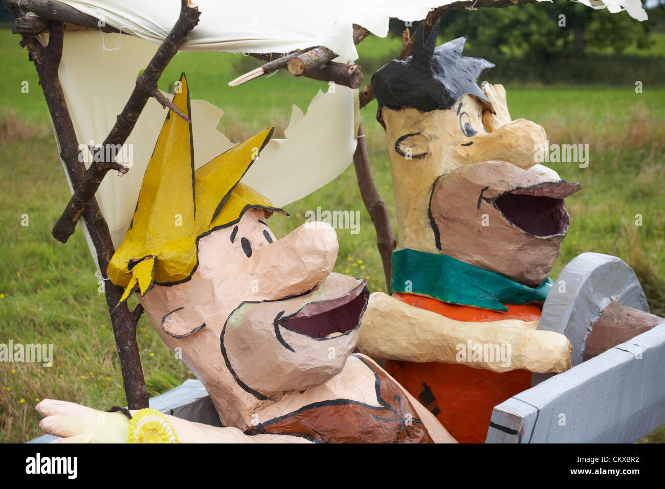 27 August 2012. Bisterne, New Forest National Park, Hampshire, UK. Bisterne Scarecrow Festival 2012. Yubba Dubba Doo. The Flintstones in their car. Credit:  Carolyn Jenkins / Alamy Live News Stock Photo